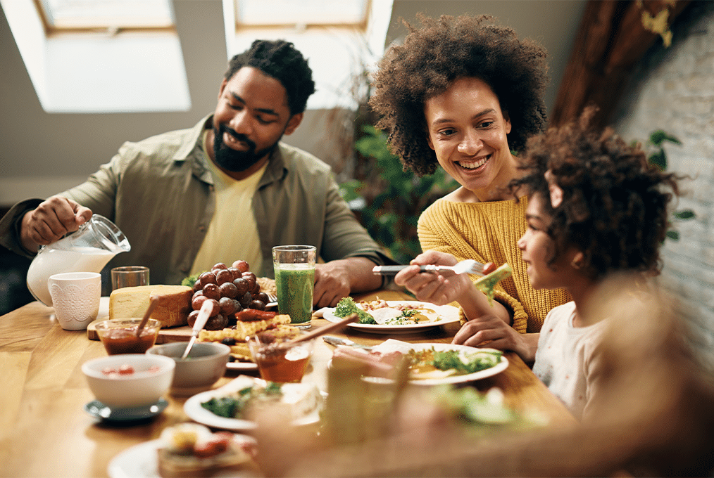 Smiling family eating a healthy meal together